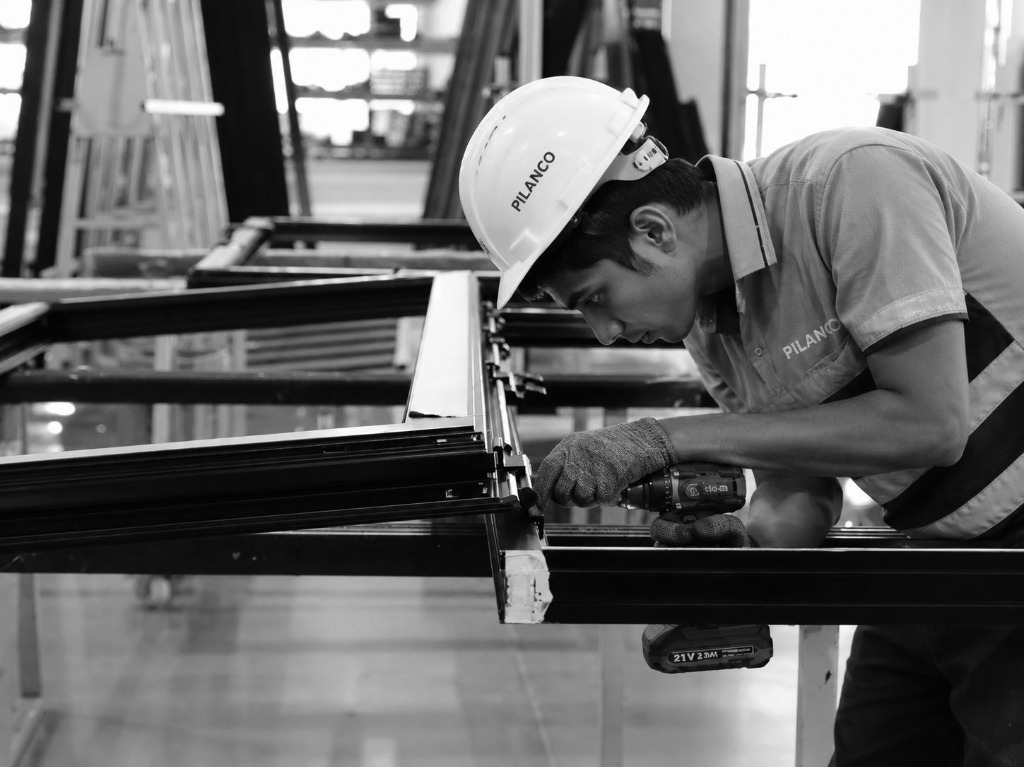 PILANCO technician manufacturing aluminium window systems